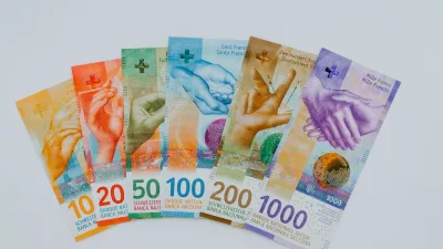10 and 100 banknotes on white table