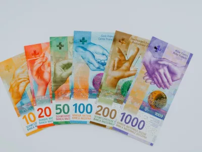10 and 100 banknotes on white table