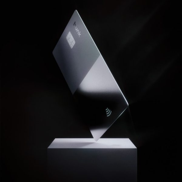 a silver credit card on top of a white stand