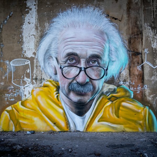 man in yellow and blue hoodie wearing eyeglasses