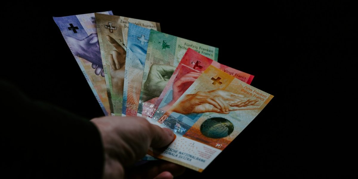 person holding 10 and 20 philippine peso bill