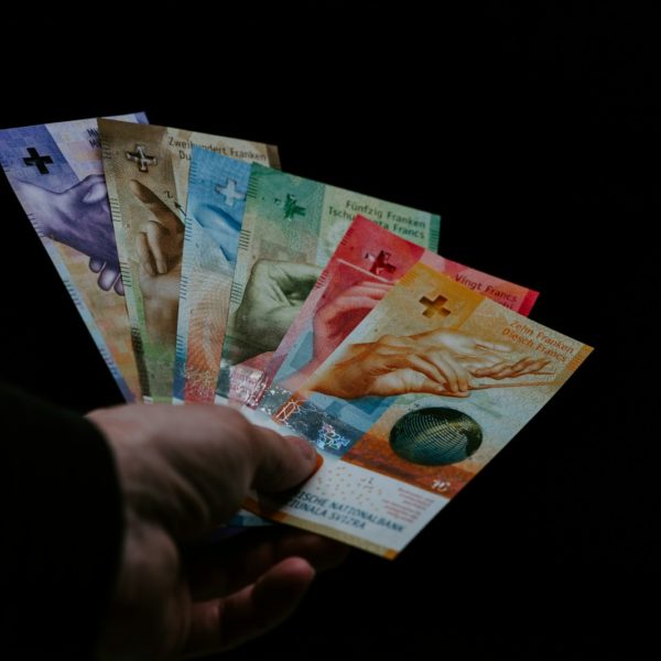 person holding 10 and 20 philippine peso bill